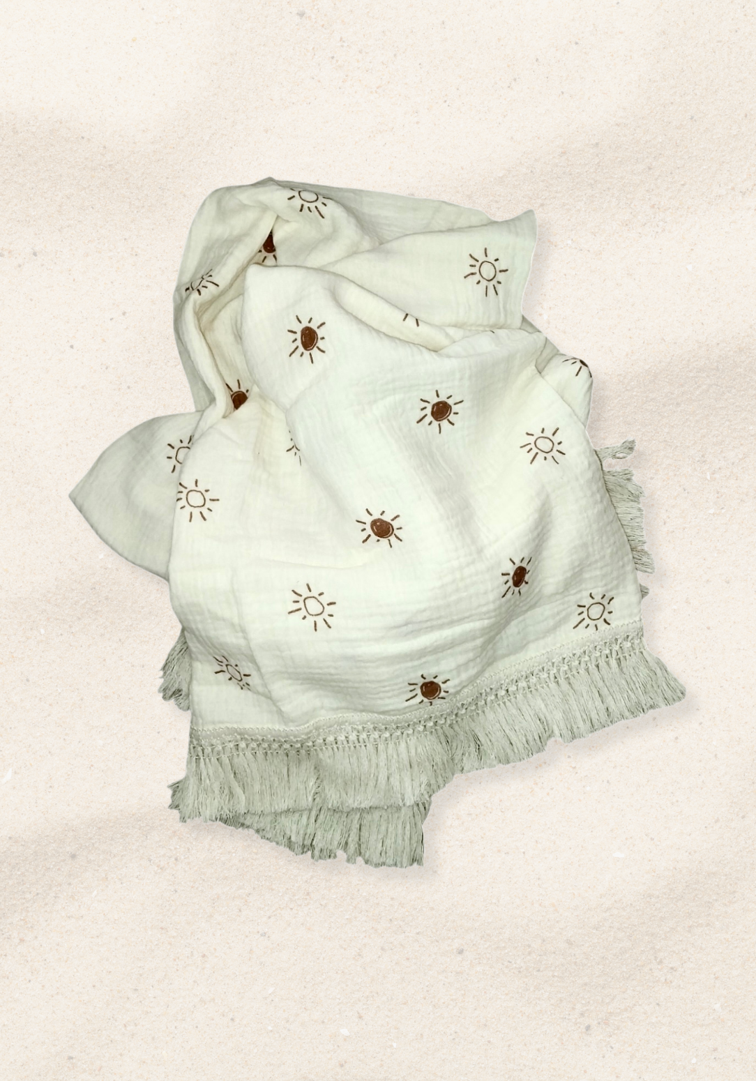 White baby blanket with hand-drawn brown sun print and cream fringe, crafted from cotton and bamboo blend.