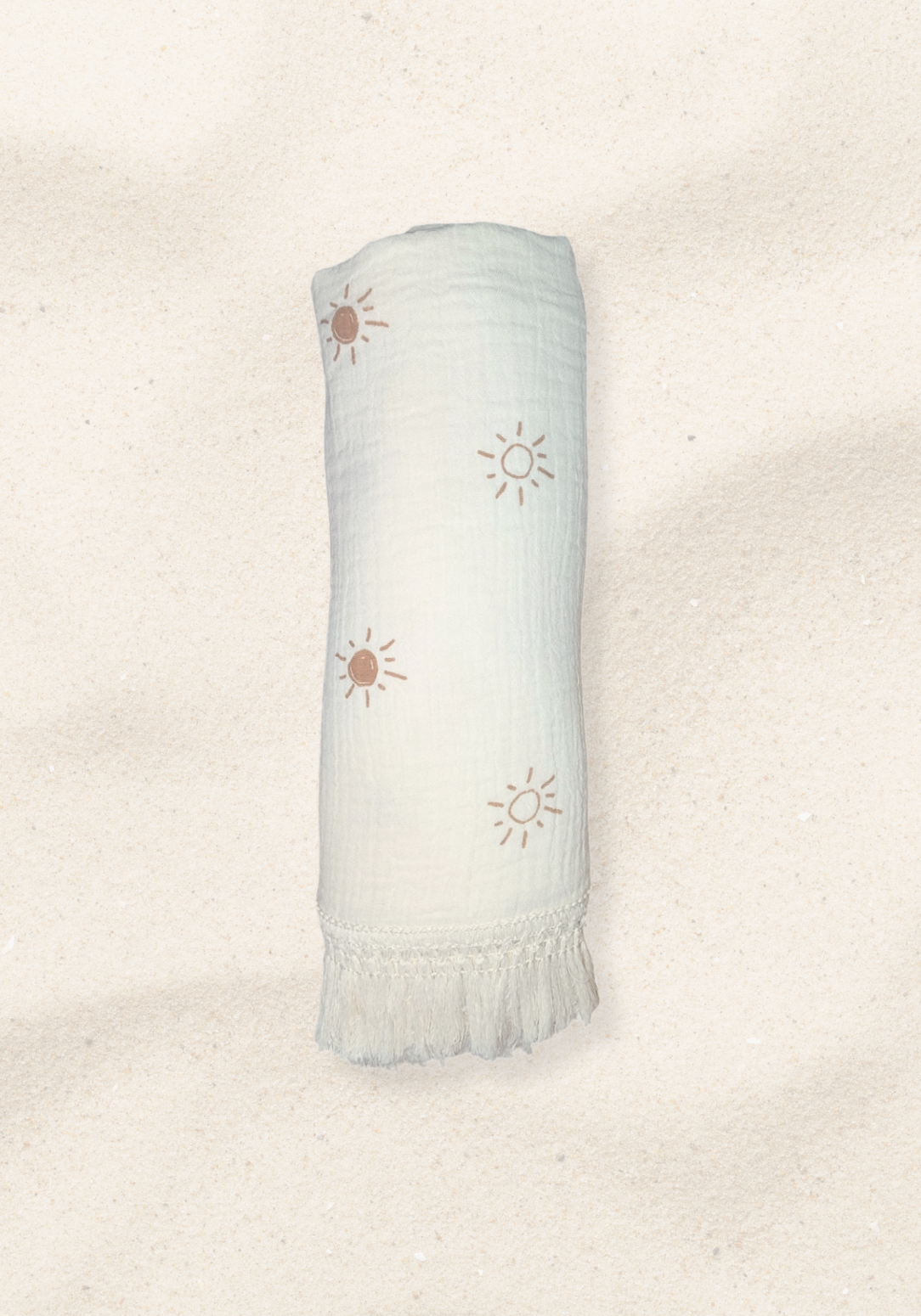 White baby blanket with hand-drawn brown sun print and cream fringe, crafted from cotton and bamboo blend.