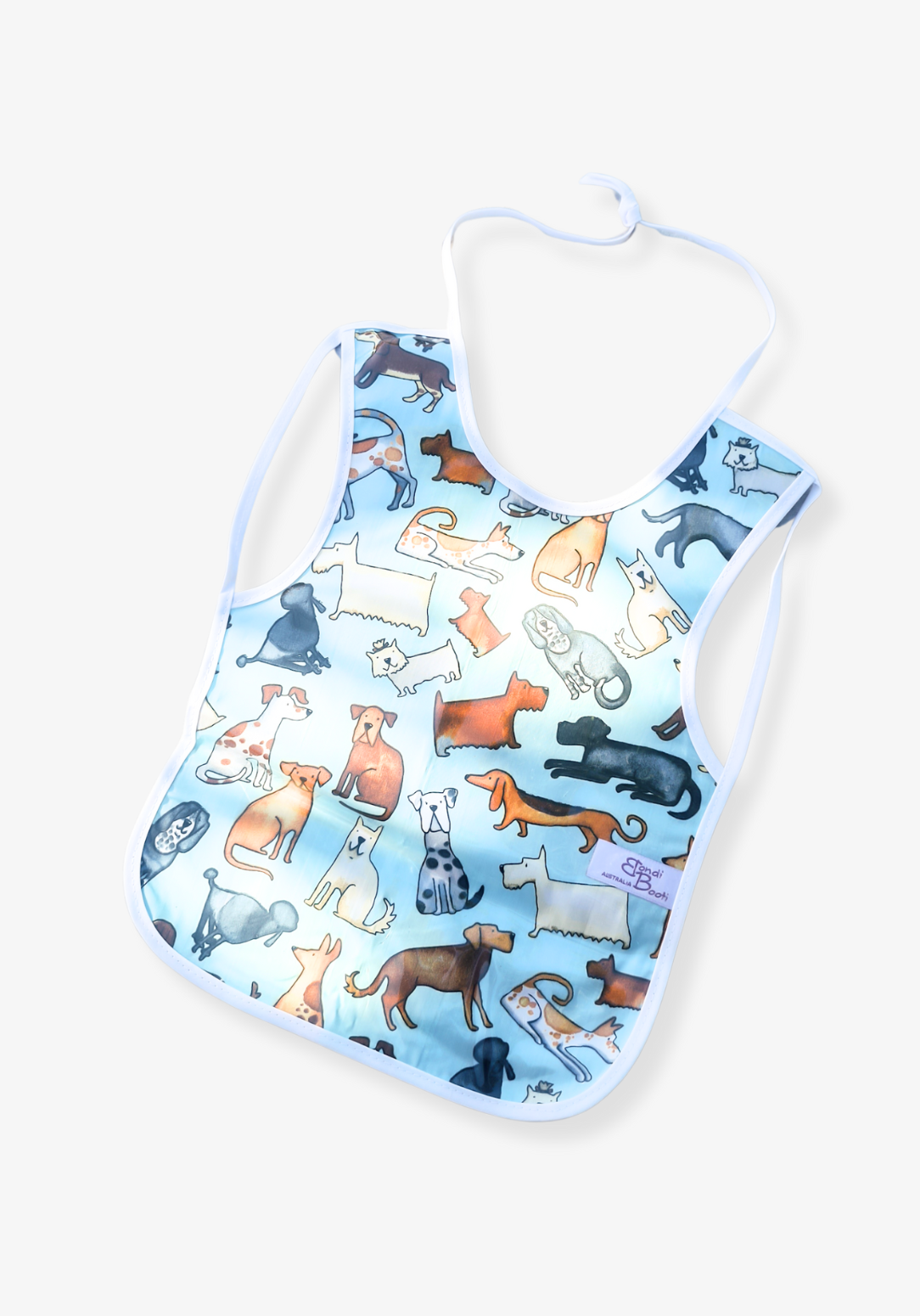 Laminated baby feeding bib featuring a playful pattern of illustrated dogs in various breeds and colors on a light blue background, trimmed in white with a snap closure, laid flat on a grey background.