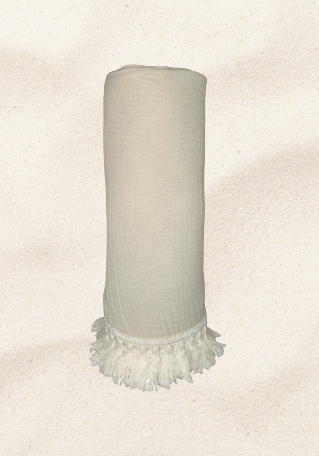 Rolled neutral-colored organic cotton baby blanket with white tassel fringe, displayed upright against a white background.