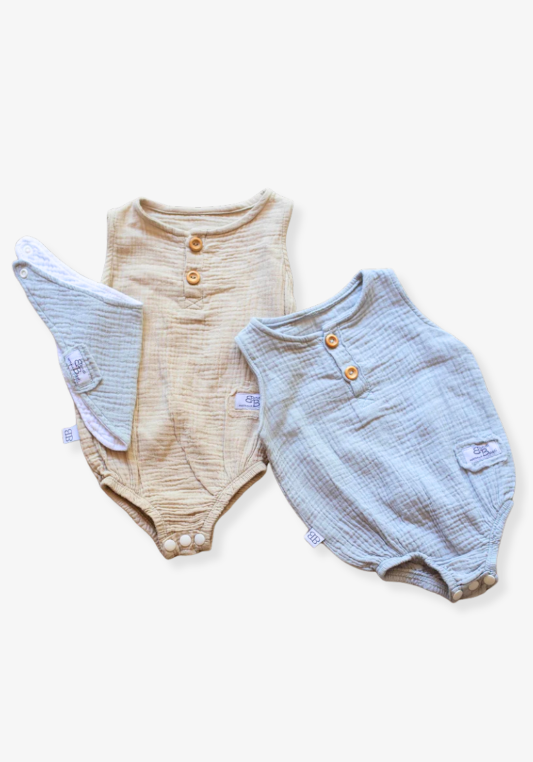 Beige baby romper made of organic cotton with wooden button front and soft texture, displayed on a grey background