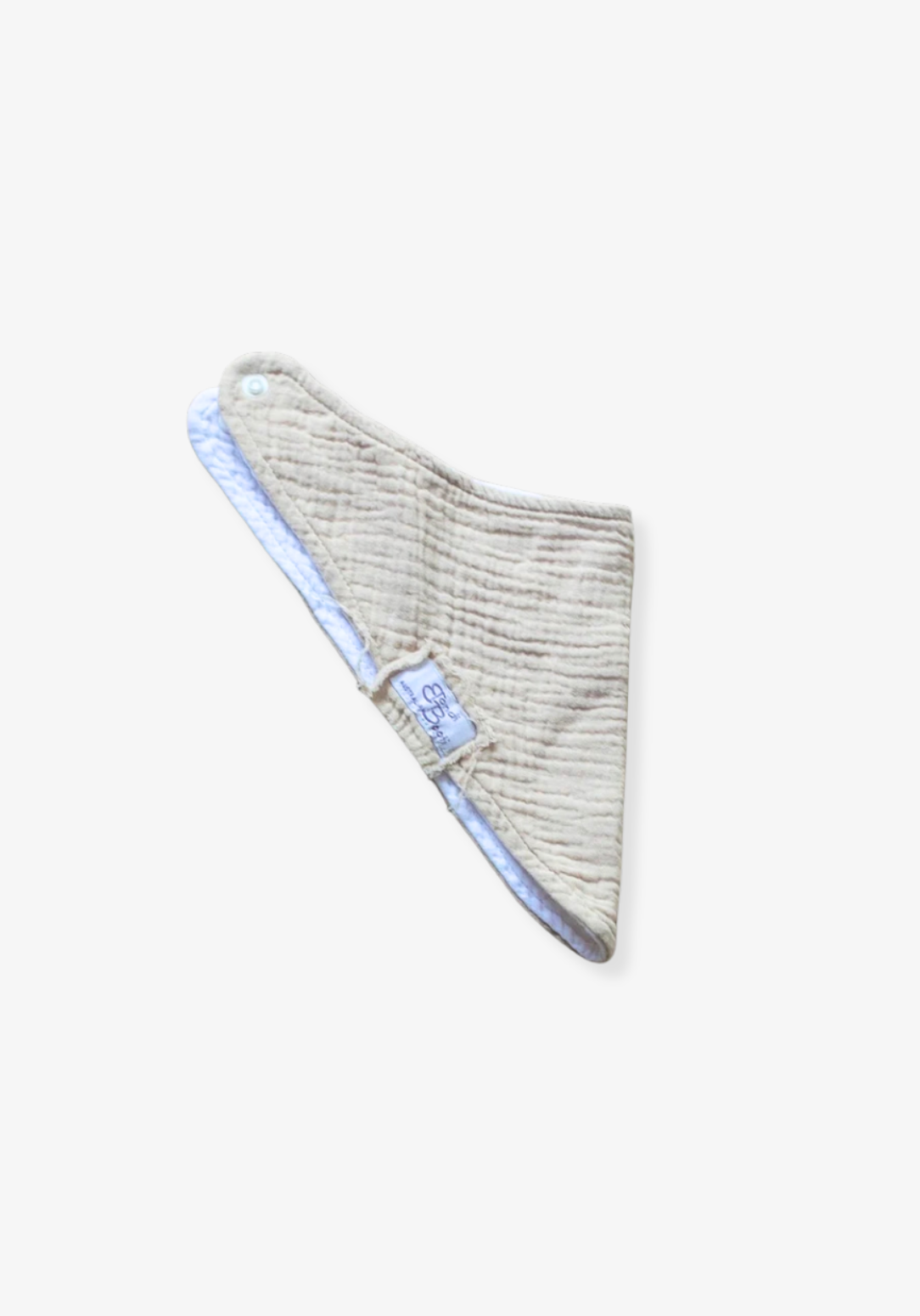 Soft beige organic cotton bandana dribble bib for babies with rounded shape and snap closure, displayed on a grey background