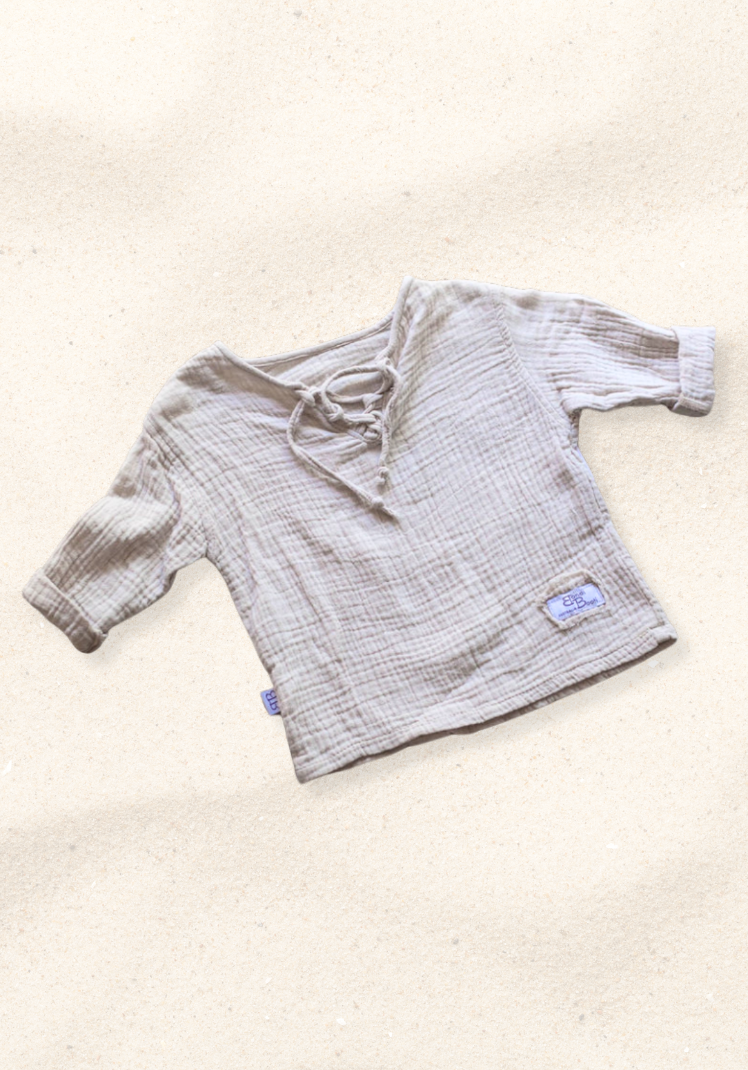 Beige long sleeve baby pirate shirt made from organic cotton with soft gathered neckline