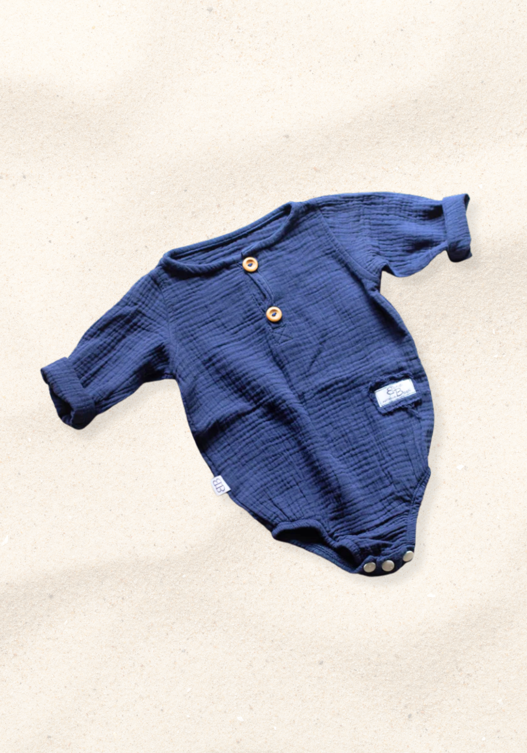 Long sleeve navy baby romper crafted from soft organic cotton with button-up front