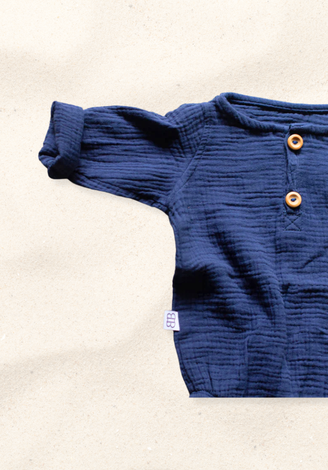 Long sleeve navy baby romper crafted from soft organic cotton with button-up front
