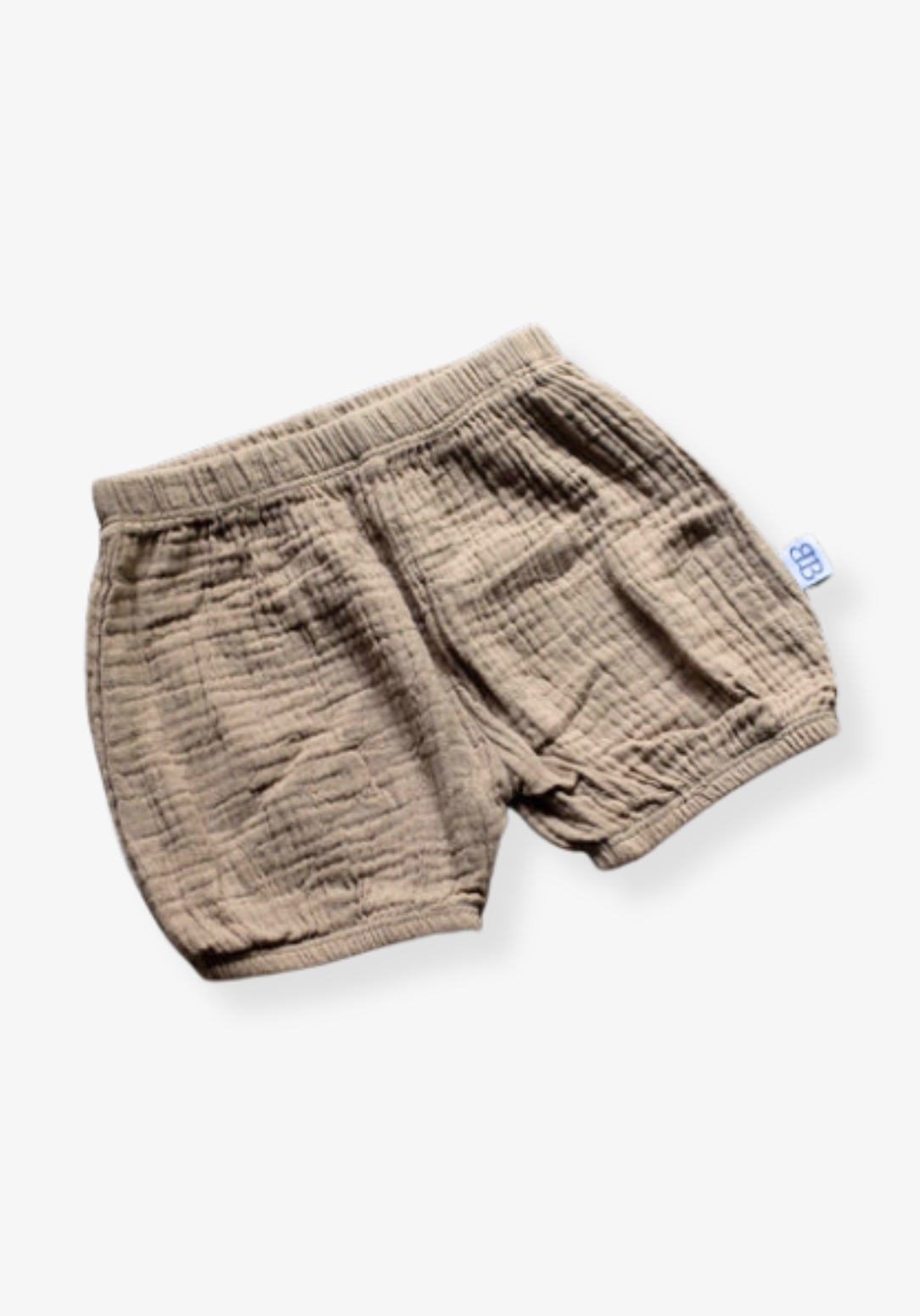 Three-pack of organic cotton baby bloomers in assorted neutral tones with elastic waist and leg openings