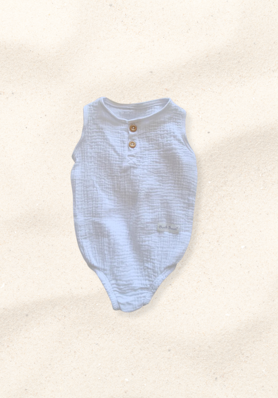 White organic cotton baby romper with three snap buttons and elasticised leg bands