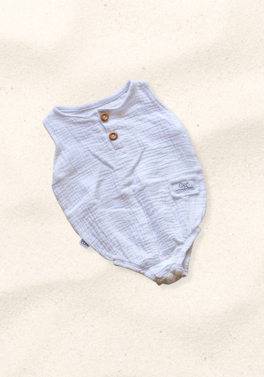 White organic cotton baby romper with three snap buttons and elasticised leg bands