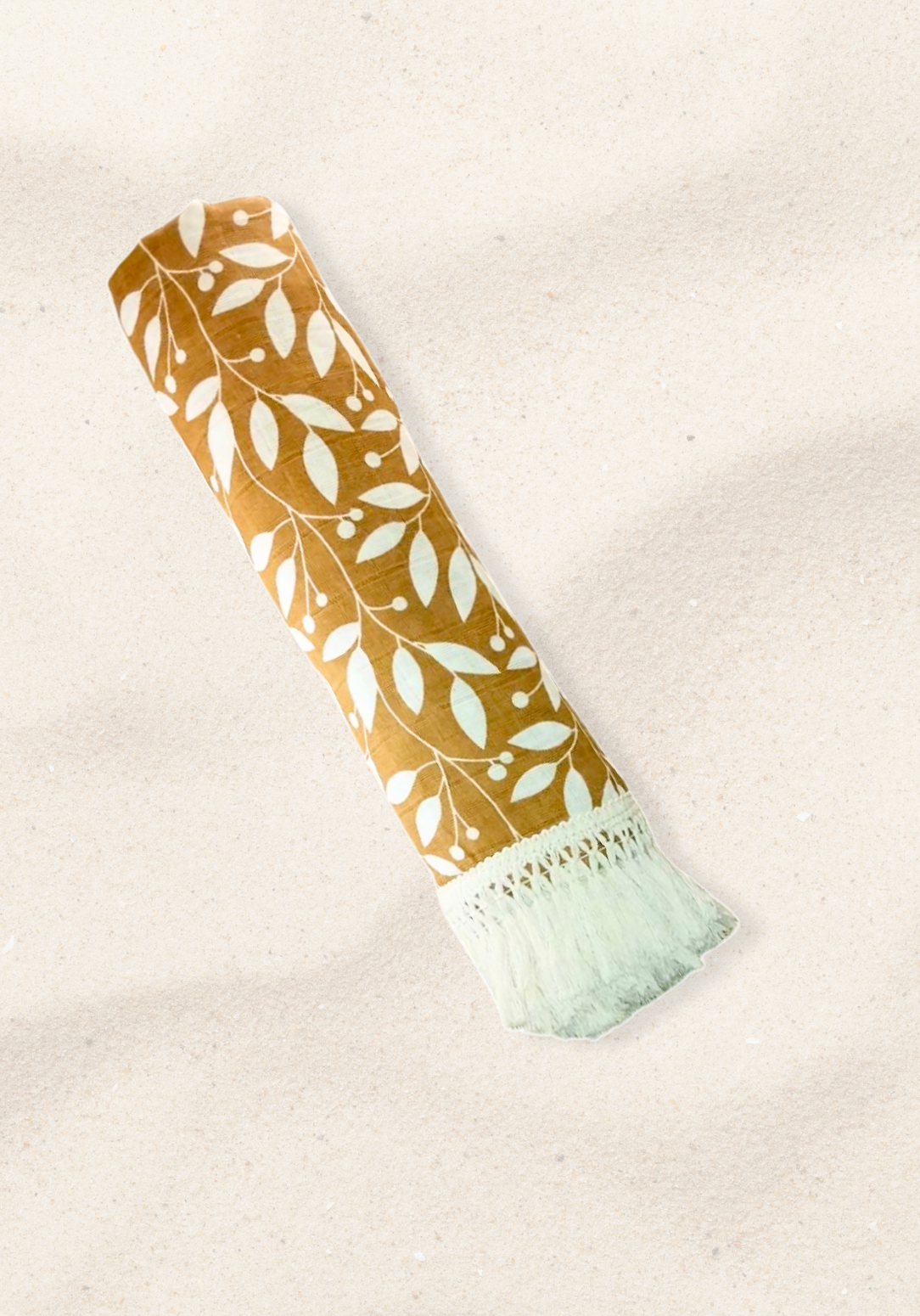 Rolled mustard brown cotton baby blanket with delicate white leaf print and cream fringe trim. Lightweight and breathable for babies.