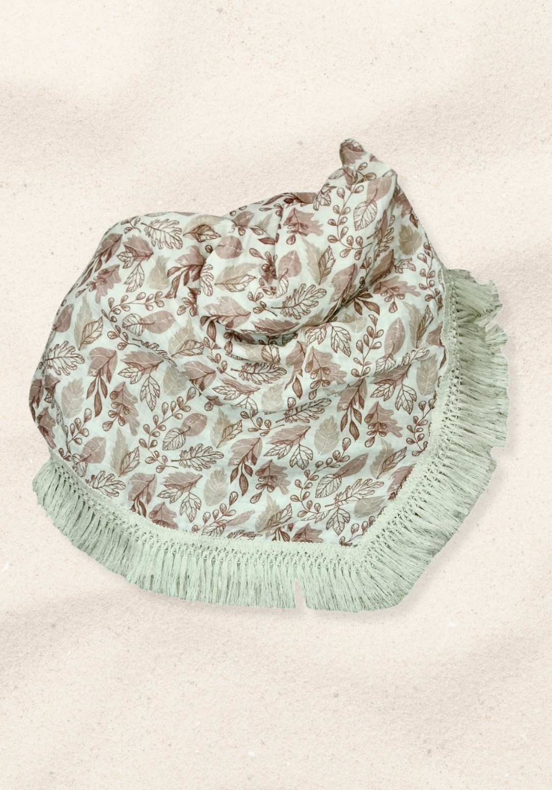 White baby blanket featuring brown and beige leaf patterns with thick fringe trim. Soft cotton-bamboo blend for year-round comfort.