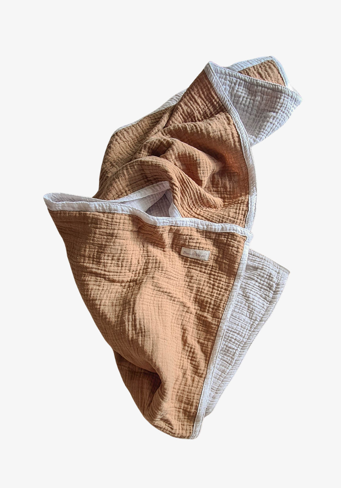 Reversible baby blanket in warm brown and white organic cotton, with visible Bondi Booti and “Made in Australia” labels, displayed on a neutral fabric background.