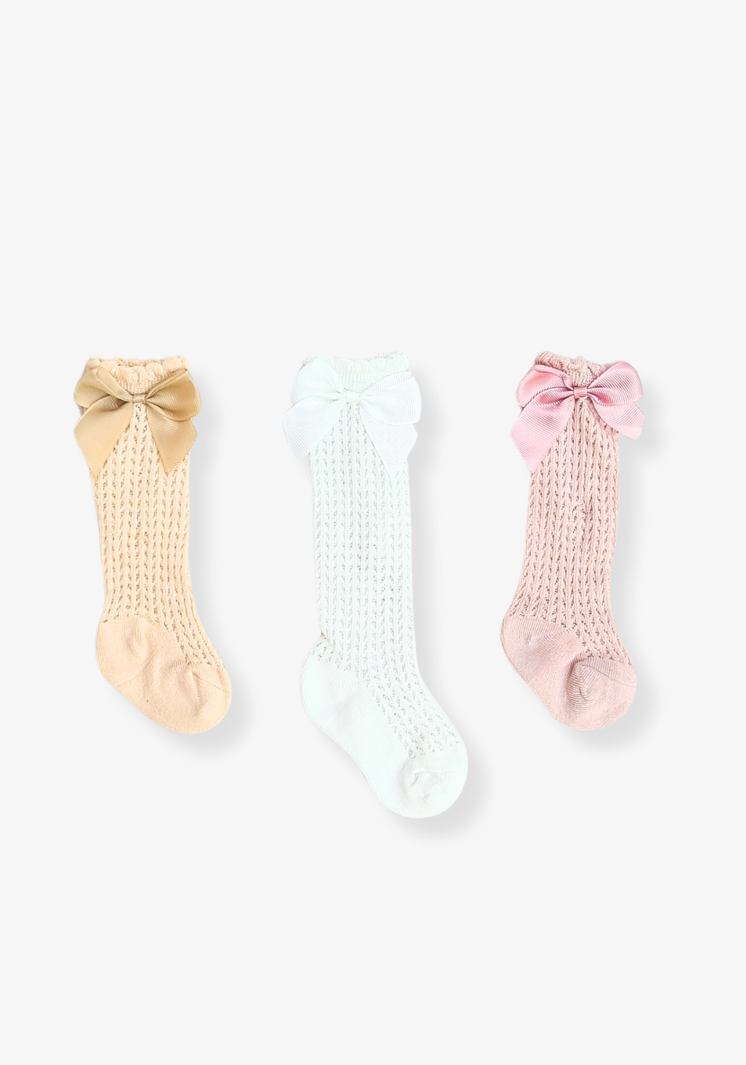 Set of three baby girl knee-high socks in beige, white, and pink with large decorative bows