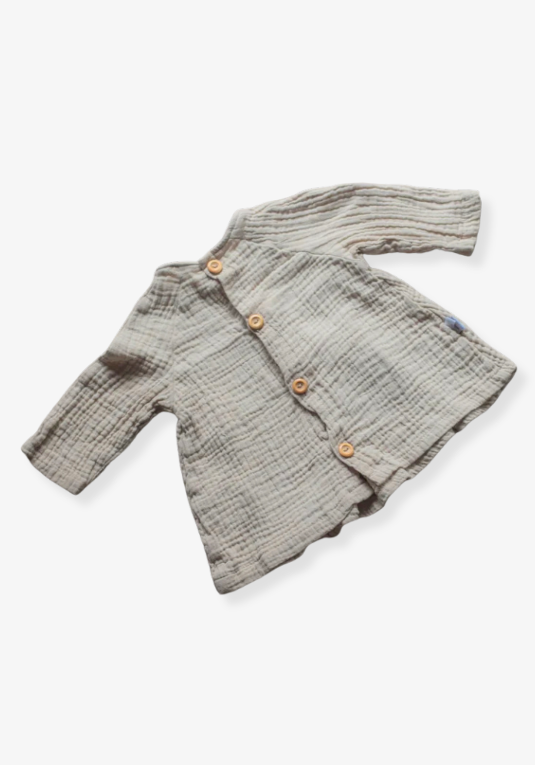 Boho-style baby dress in beige with embroidered hem, made from breathable cotton and displayed on a neutral grey background