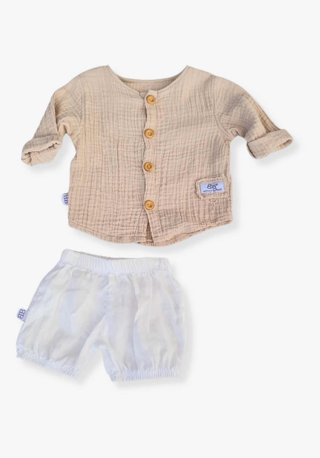 Beige organic cotton island-style shirt for babies and toddlers, featuring front wooden buttons and rolled sleeves