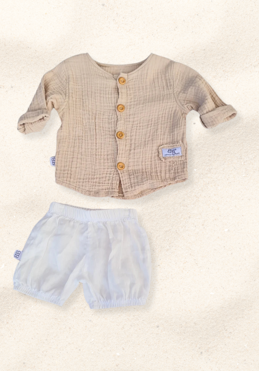 Beige organic cotton island-style shirt for babies and toddlers, featuring front wooden buttons and rolled sleeves