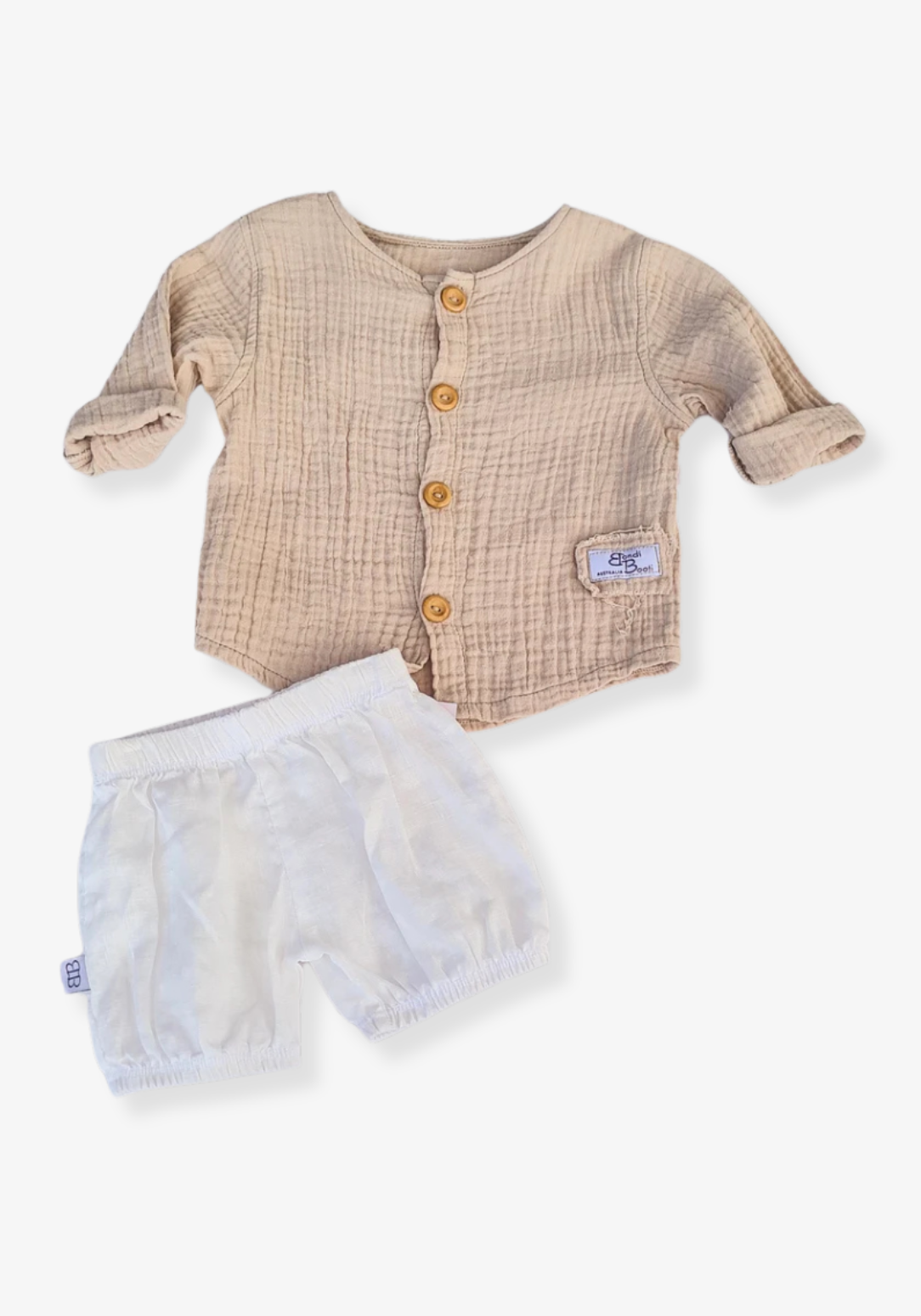 Beige organic cotton island-style shirt for babies and toddlers, featuring front wooden buttons and rolled sleeves