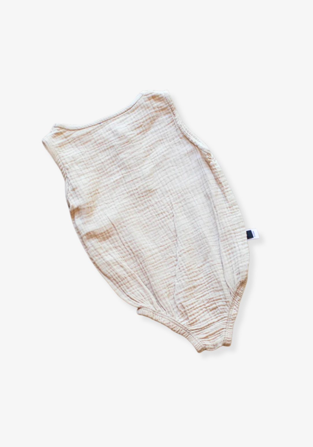 Beige baby romper made of organic cotton with wooden button front and soft texture, displayed on a grey background