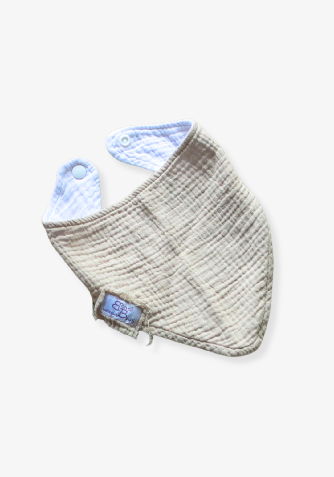 Soft beige organic cotton bandana dribble bib for babies with rounded shape and snap closure, displayed on a grey background
