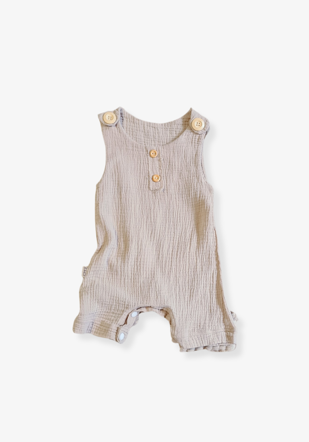 Beige organic cotton baby overall onesie with wooden button straps and soft elastic leg openings