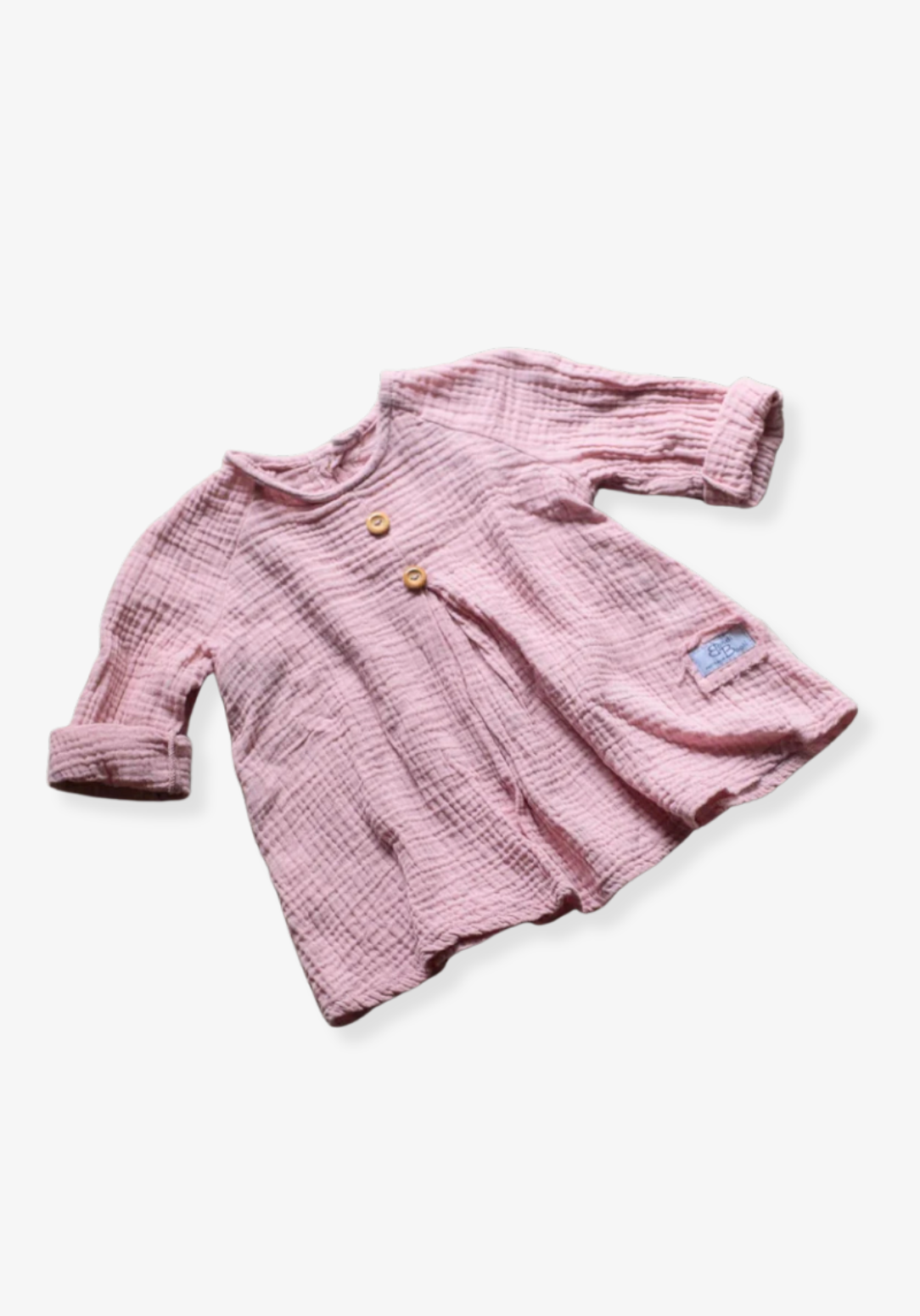 Front view of dusty pink boho muslin long sleeve baby dress with wooden buttons and soft gauze texture on grey background