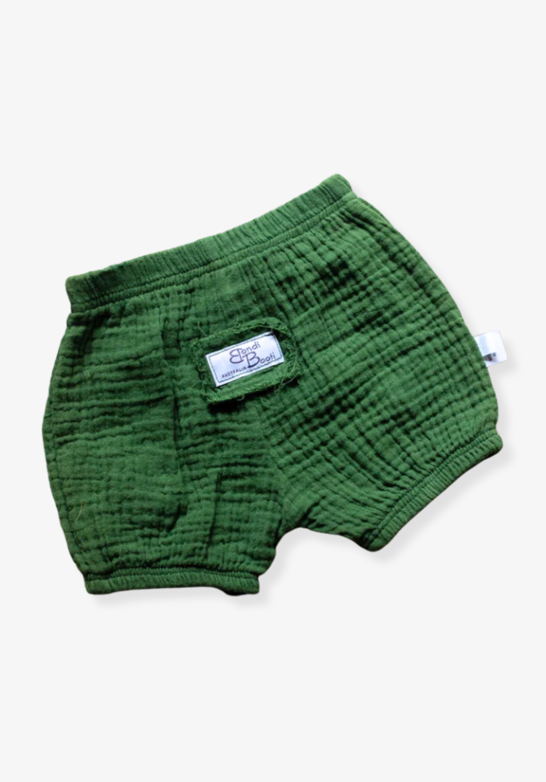 Deep green baby bloomers made from soft organic cotton with stretchy waistband, displayed on a grey background