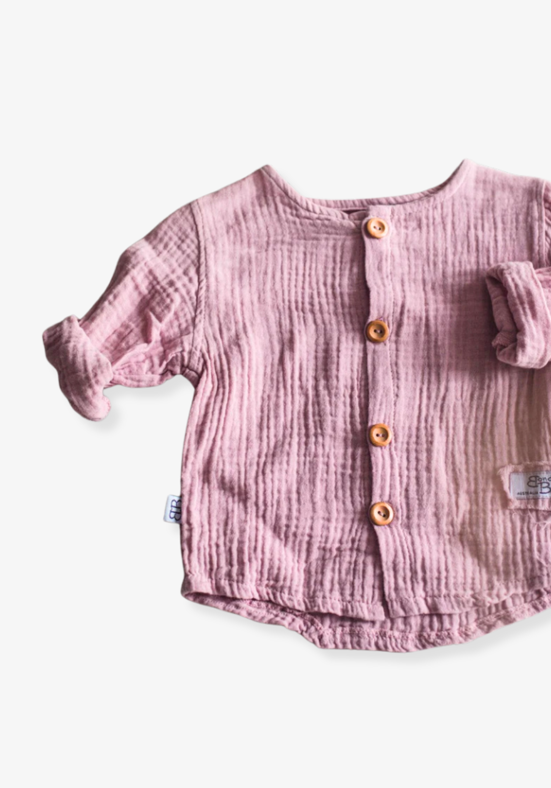 Dusty pink baby and toddler island-style shirt made from organic cotton with short sleeves and wooden buttons