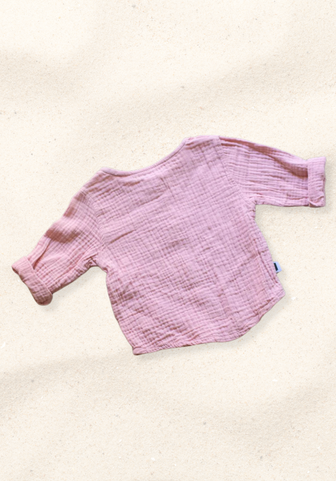 Dusty pink baby and toddler island-style shirt made from organic cotton with short sleeves and wooden buttons