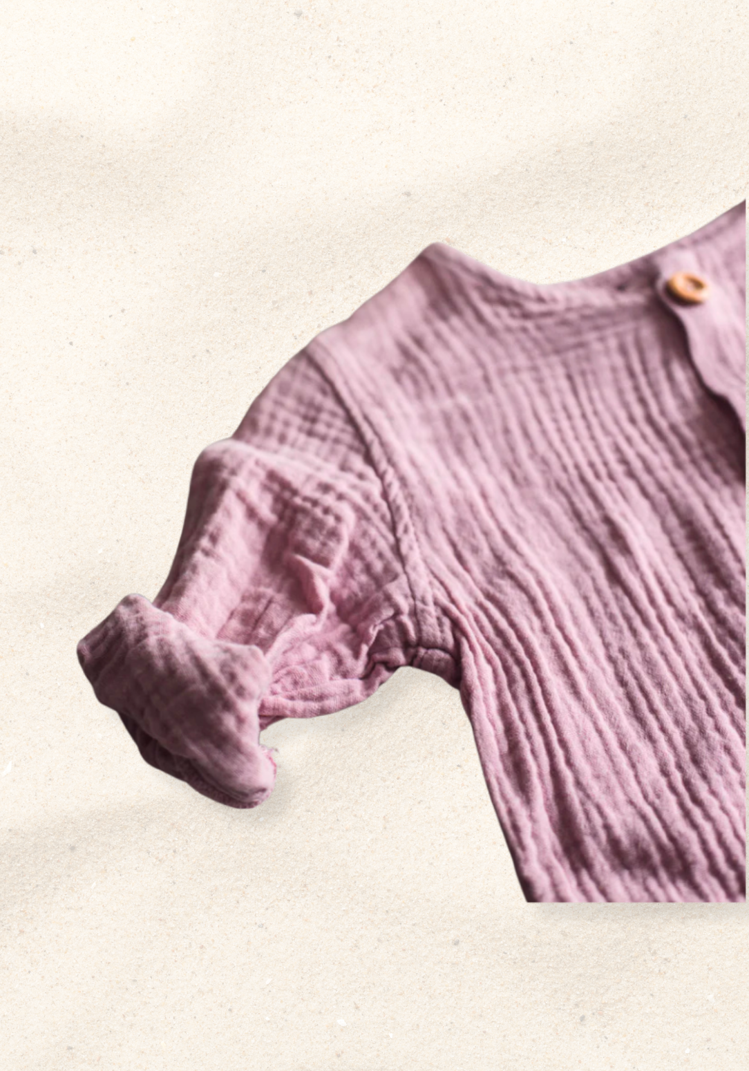 Dusty pink baby and toddler island-style shirt made from organic cotton with short sleeves and wooden buttons