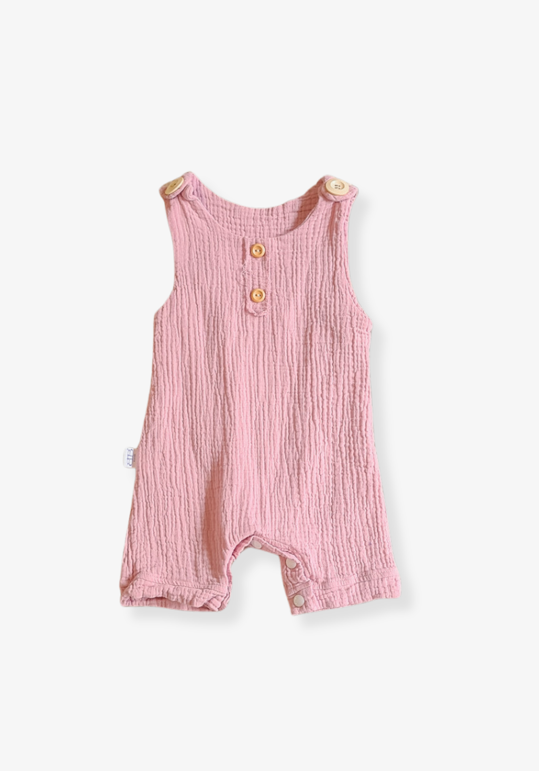 Dusty pink organic cotton baby overall onesie with wooden button shoulder straps and soft elastic leg openings