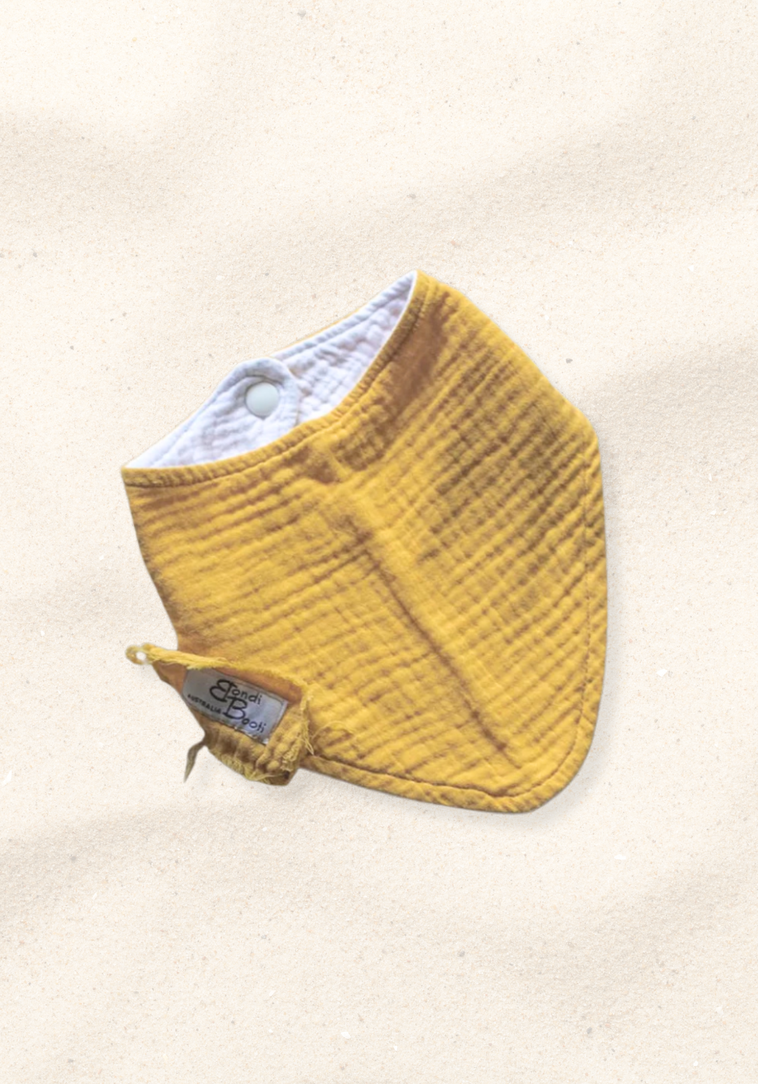 Mustard yellow organic cotton baby bandana dribble bib with soft fabric and snap closure.