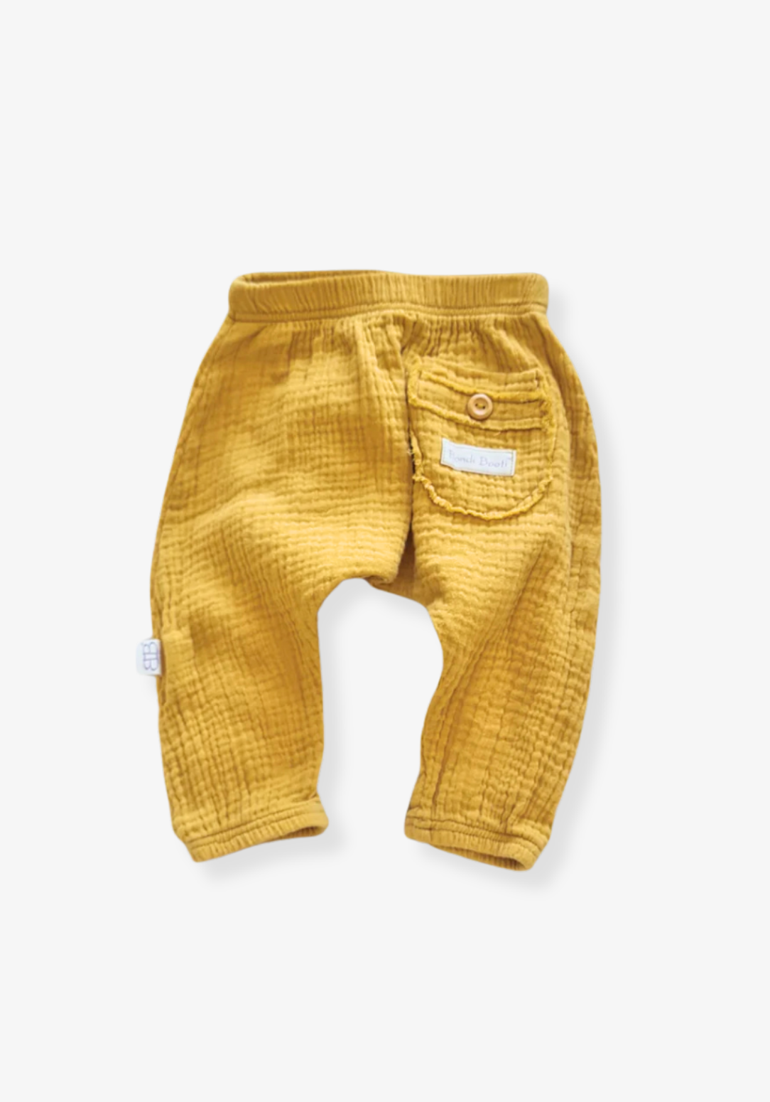 Toddler harem pants in mustard yellow made from organic cotton with a wooden button and soft elastic waistband