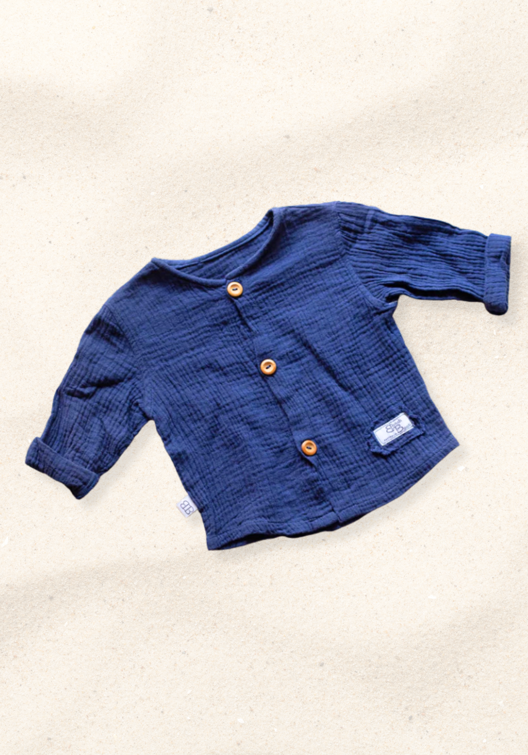 Navy island-style baby and toddler shirt made from organic cotton with wooden buttons and short sleeves