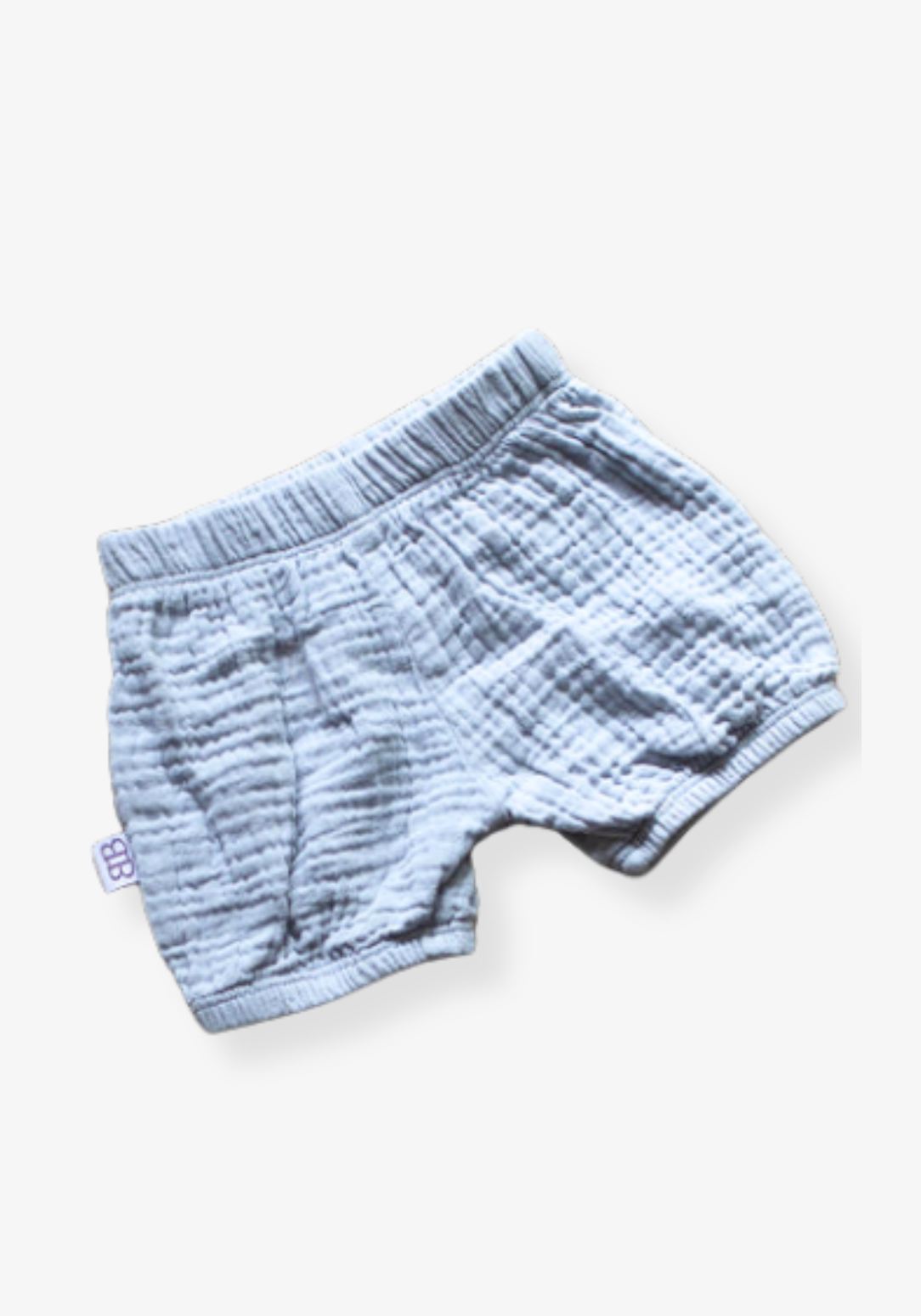 Three-pack of organic cotton baby bloomers in assorted neutral tones with elastic waist and leg openings
