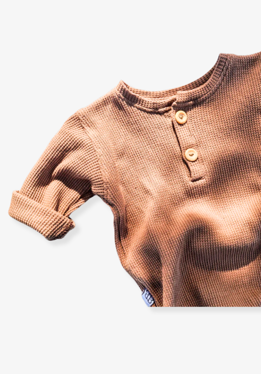 waffle knit long sleeve baby bodysuit with soft organic cotton texture and convenient snap buttons