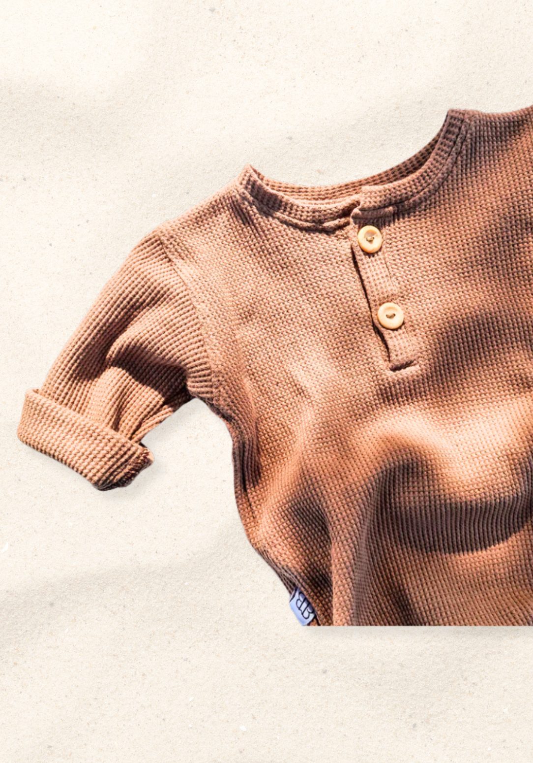 waffle knit long sleeve baby bodysuit with soft organic cotton texture and convenient snap buttons